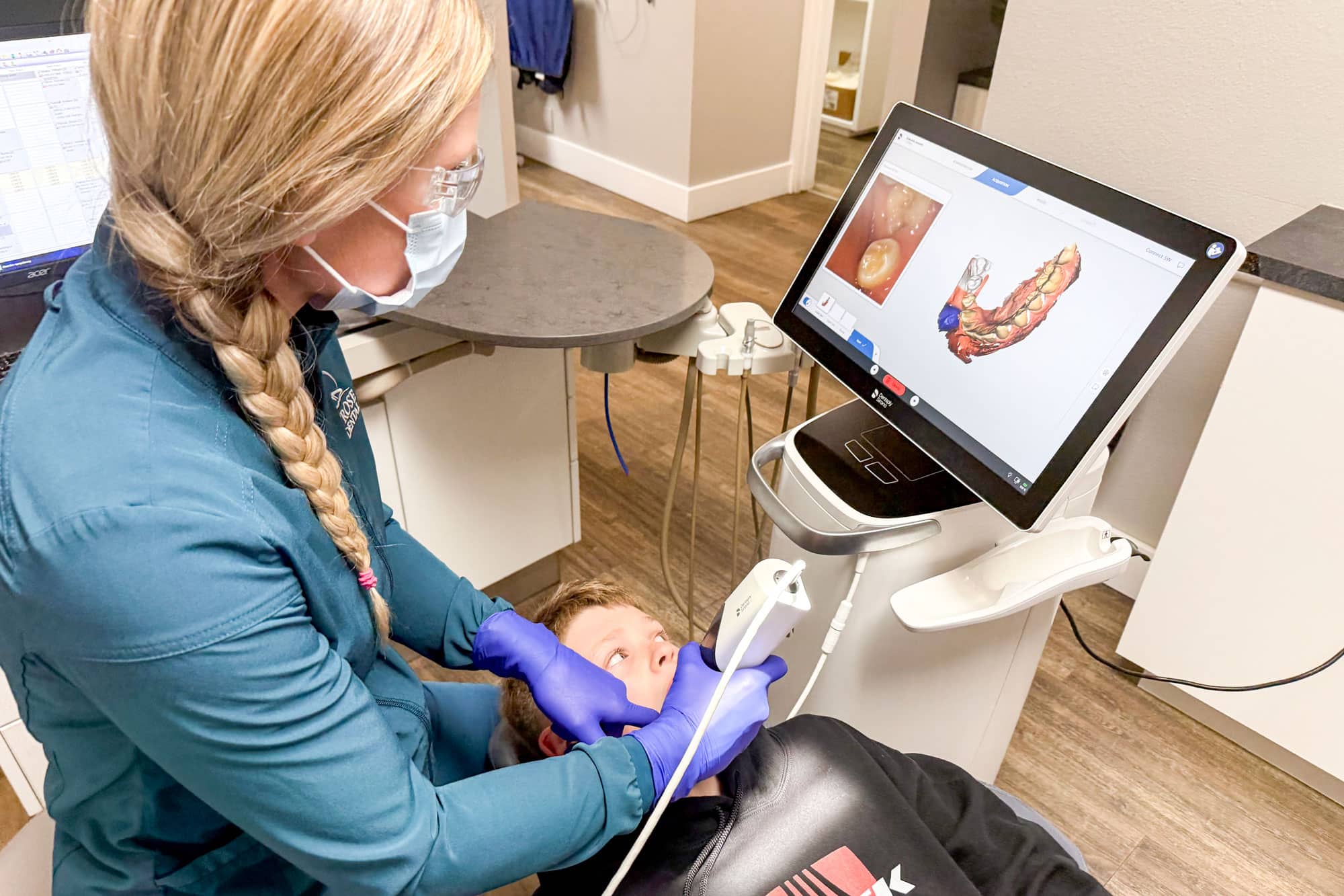 MFD Dentist Pointing at X-Ray Picture During Client Consultation