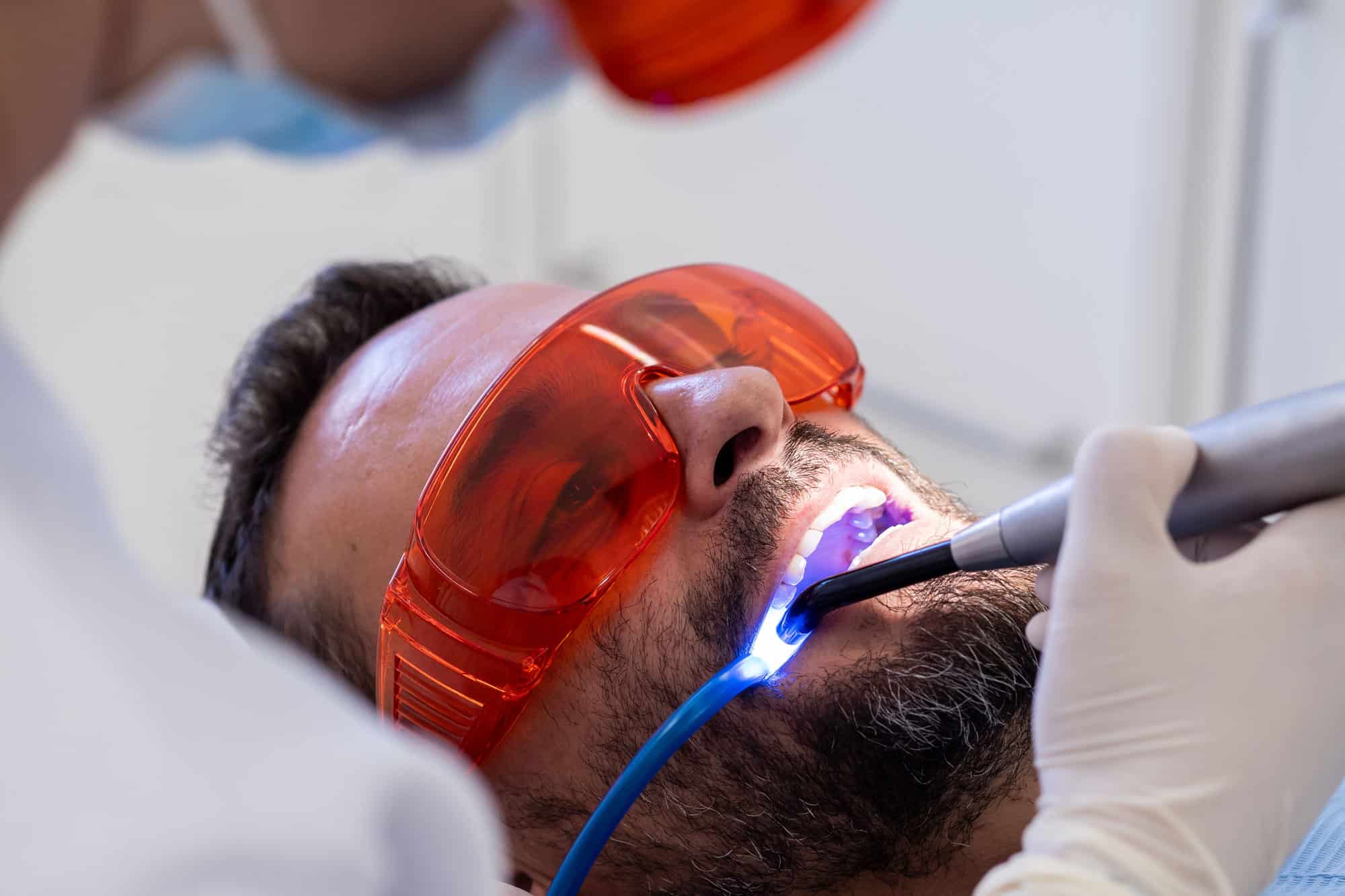 MFD Dentist Pointing at X-Ray Picture During Client Consultation