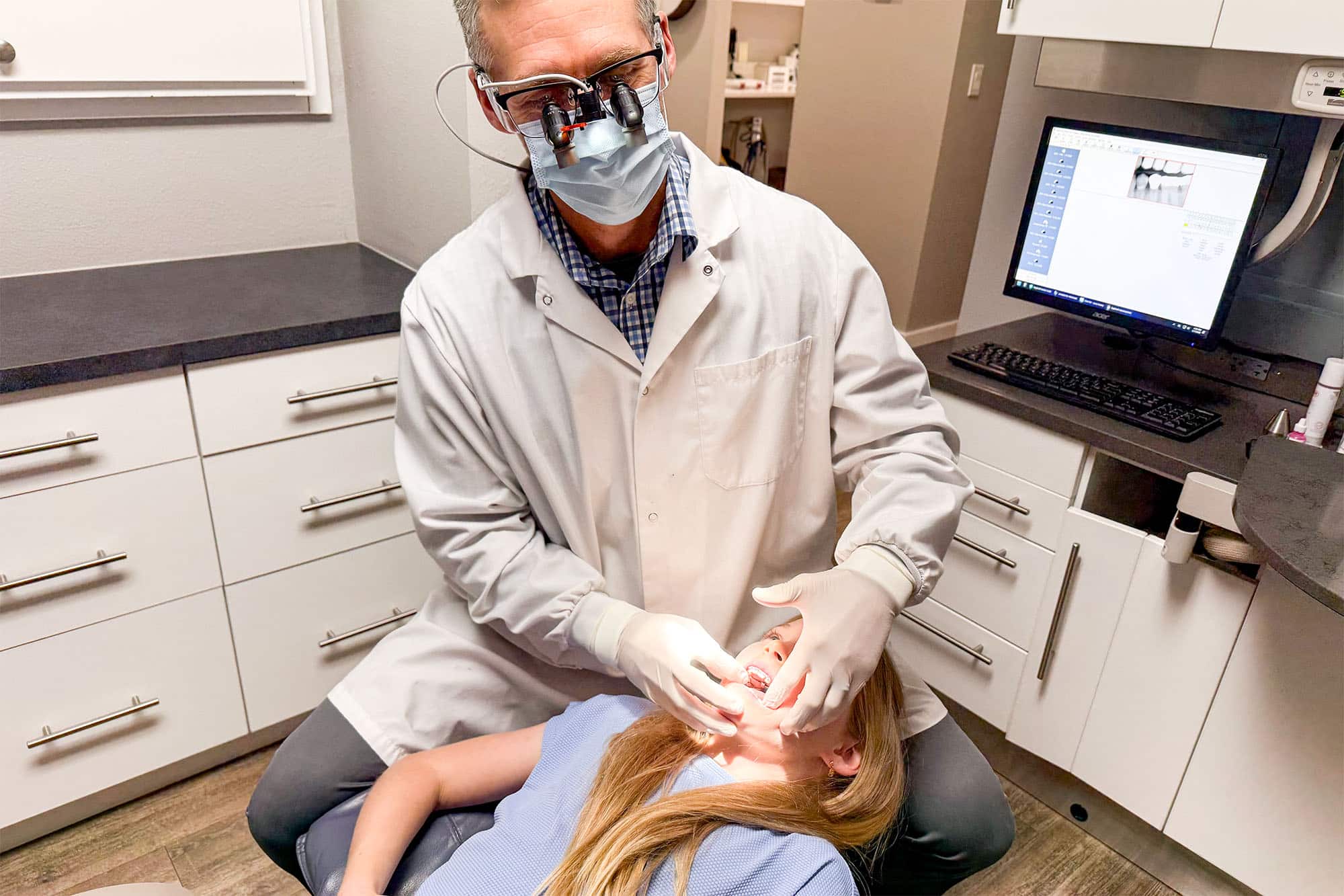 MFD Dentist Pointing at X-Ray Picture During Client Consultation