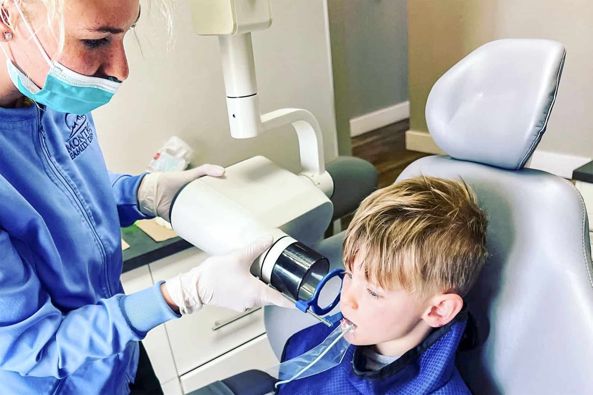 MFD Dentist Pointing at X-Ray Picture During Client Consultation